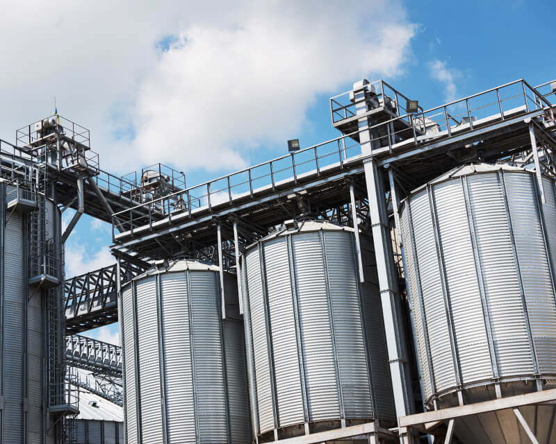Several outdoor storage tanks connected by metal walkways.