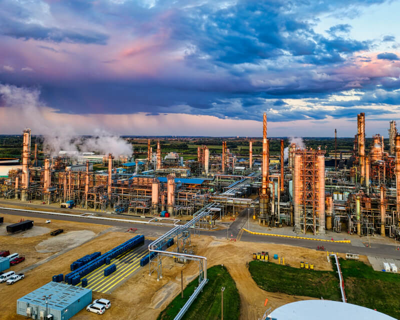Broad view of skyline with large manufacturing site in foreground.