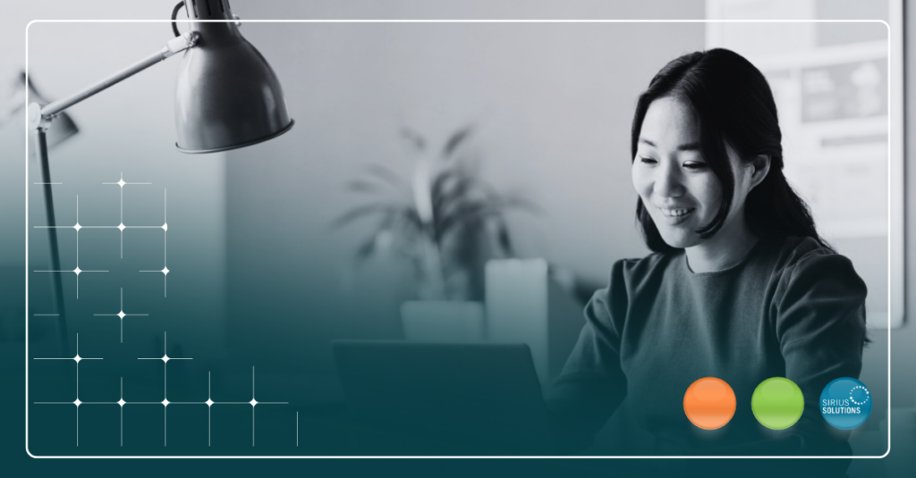 Smiling Woman Sitting at Desk with Computer